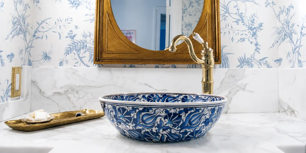 hand-painted ceramic vessel sink with intricate floral detailing