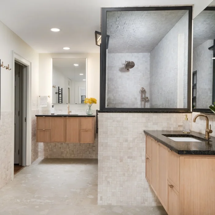 Serene primary bathroom with modern tile and decor by Armitage Interiors